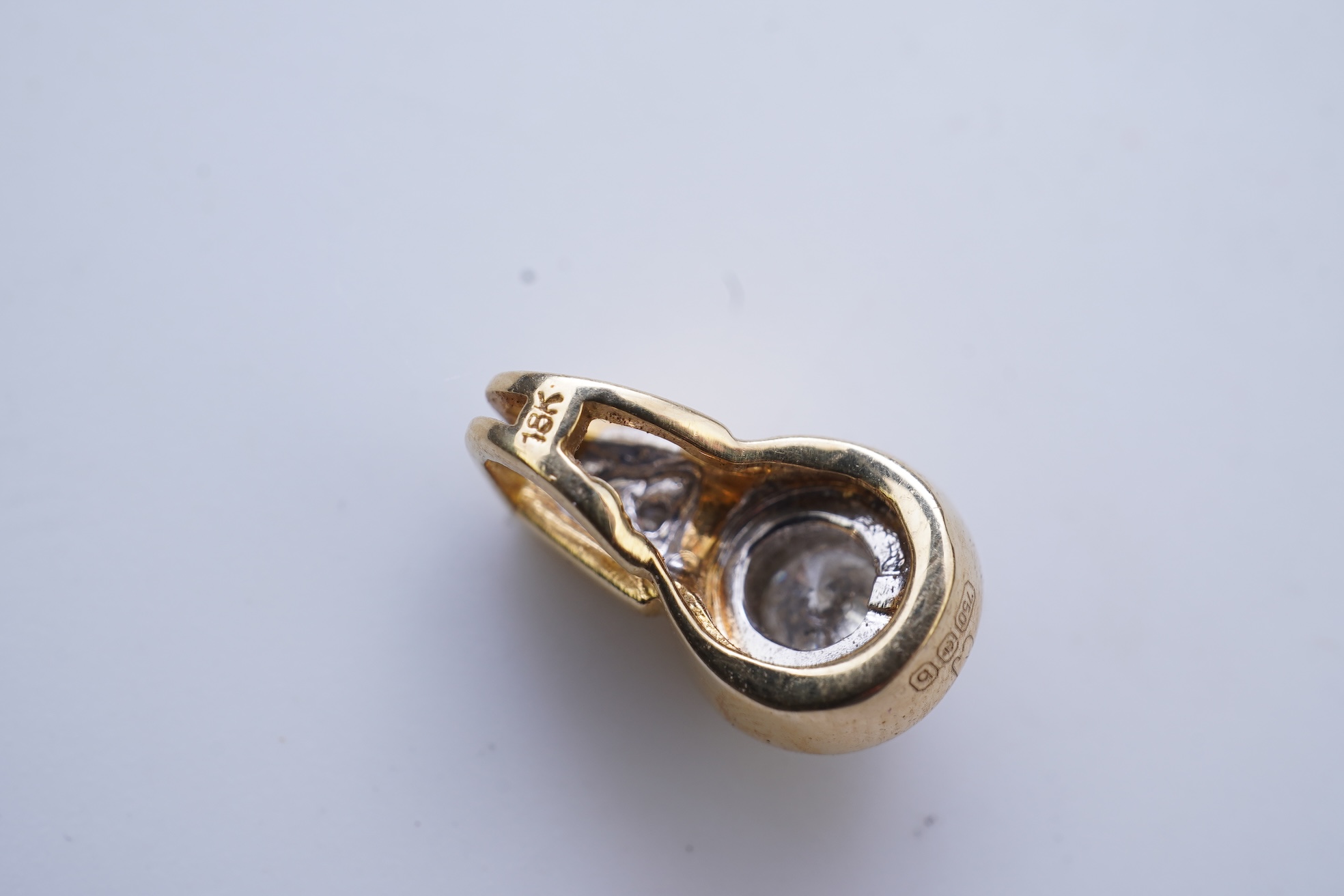 A diamond pendant and pair of diamond stud earrings